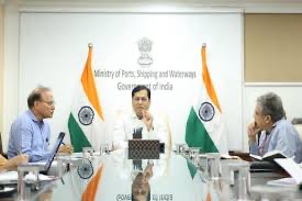 Sarbananda Sonowal at the head of a conference table, in front of a backdrop reading Ministry of Ports, Shipping and Waterways, Government of India