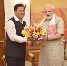 Sarbananda Sonowal presents a bouquet to Prime Minister Narendra Modi